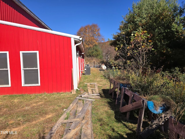 view of side of property with a lawn