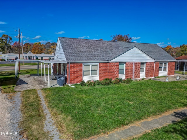 view of front of property with a patio, roof with shingles, a pergola, a front lawn, and brick siding