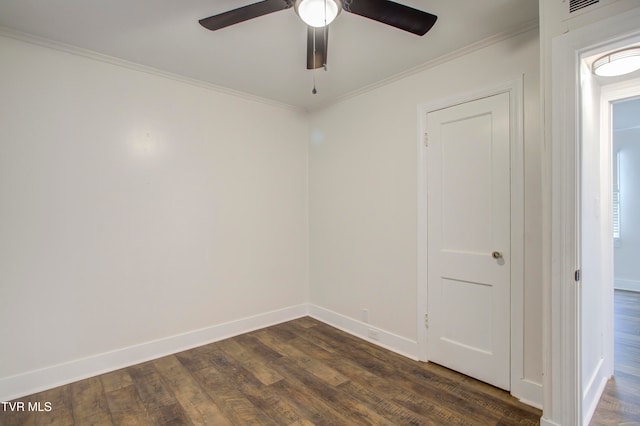 spare room with a ceiling fan, crown molding, baseboards, and dark wood-type flooring