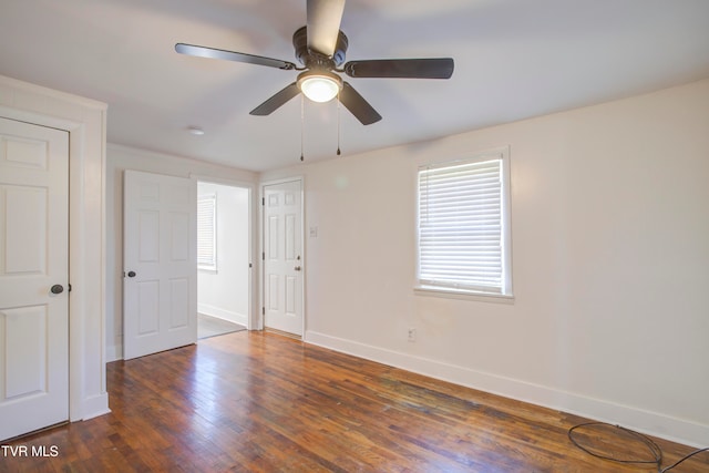 unfurnished bedroom with baseboards, wood finished floors, and a ceiling fan