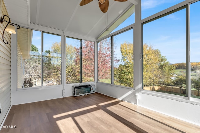 unfurnished sunroom featuring lofted ceiling, a wall mounted air conditioner, a wealth of natural light, and ceiling fan