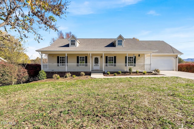 view of front of property featuring a garage, a front yard, and covered porch