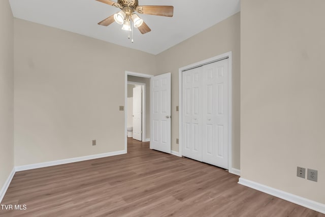 unfurnished bedroom with light hardwood / wood-style floors, a closet, and ceiling fan