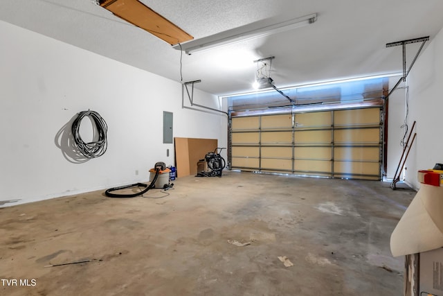 garage with a garage door opener and electric panel