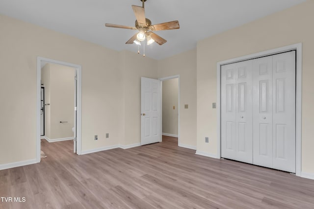 unfurnished bedroom featuring light hardwood / wood-style flooring, a closet, ceiling fan, and ensuite bathroom