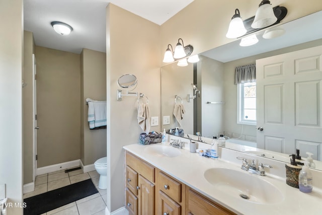 bathroom featuring vanity, toilet, tile patterned flooring, and a washtub