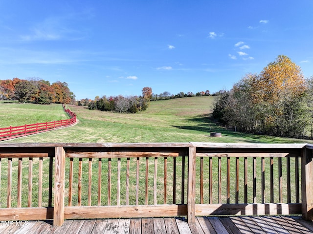 deck featuring a yard and a rural view