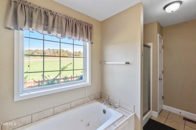 bathroom with independent shower and bath and tile patterned flooring