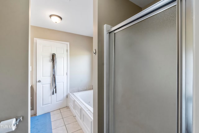 bathroom featuring shower with separate bathtub and tile patterned flooring