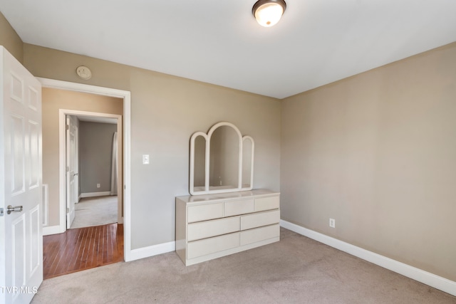 unfurnished room featuring light colored carpet