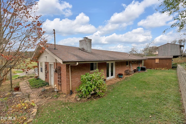 rear view of house featuring a lawn