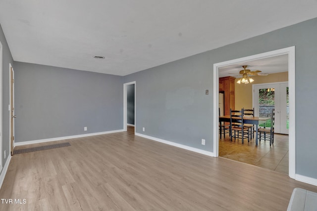 empty room featuring ceiling fan and light hardwood / wood-style flooring