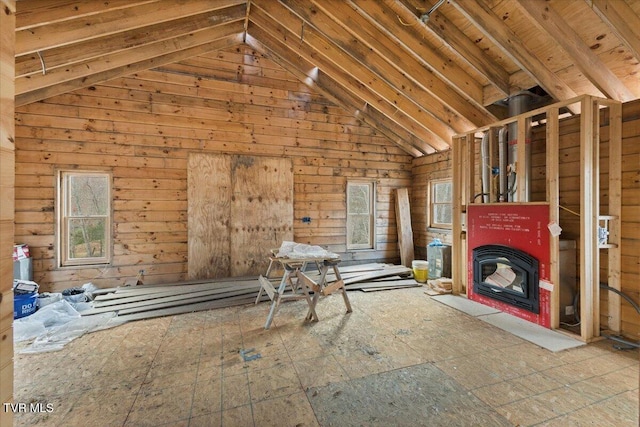 unfurnished living room with wood walls and lofted ceiling