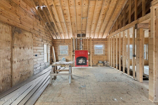 miscellaneous room with vaulted ceiling and a fireplace