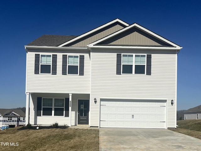 view of front of home with an attached garage and concrete driveway