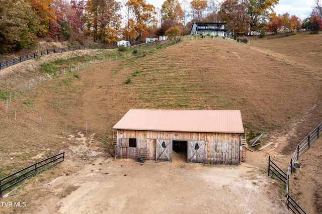 exterior space with a rural view and an outbuilding