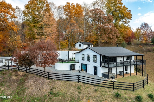 back of house featuring a wooden deck and a lawn