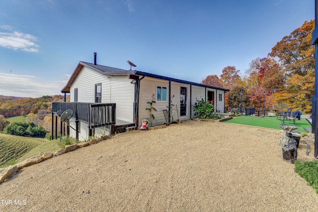 view of front of house with a front yard and a patio area