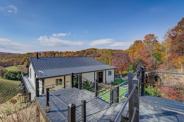 rear view of house featuring a wooden deck