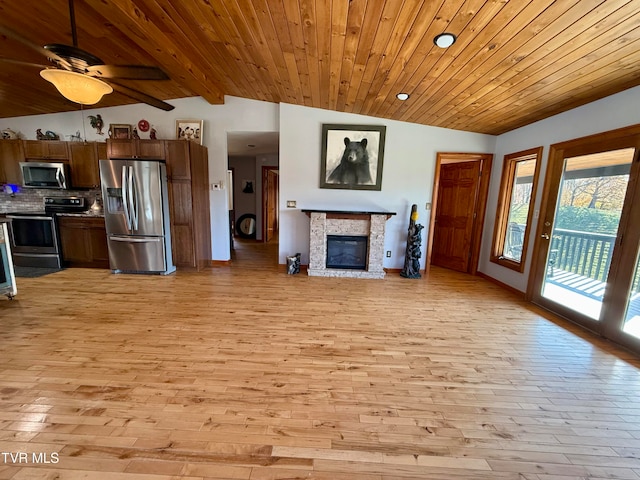 unfurnished living room with vaulted ceiling with beams, light hardwood / wood-style flooring, wooden ceiling, and ceiling fan