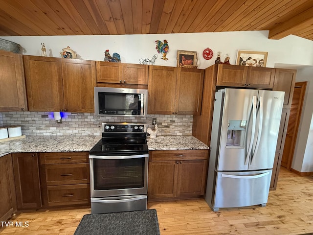 kitchen featuring light stone countertops, appliances with stainless steel finishes, light wood-type flooring, wooden ceiling, and vaulted ceiling