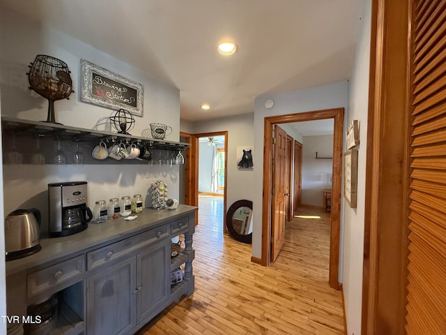 hallway with light hardwood / wood-style floors