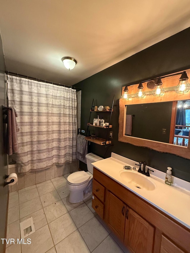 bathroom with vanity, toilet, and tile patterned flooring