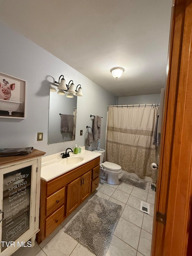 bathroom featuring vanity, toilet, a shower with curtain, and tile patterned flooring