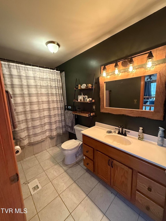 bathroom featuring vanity, toilet, and tile patterned floors