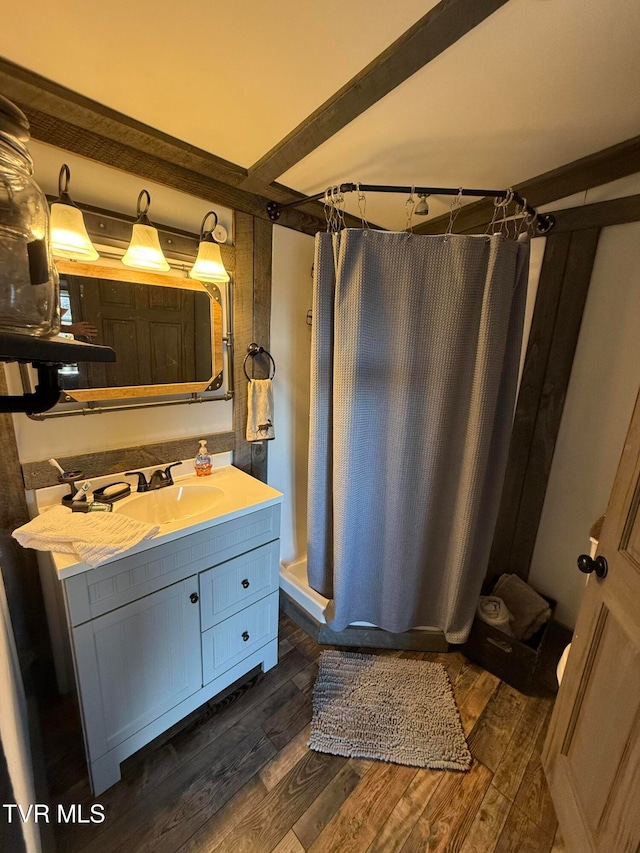 bathroom featuring vanity, hardwood / wood-style floors, and walk in shower