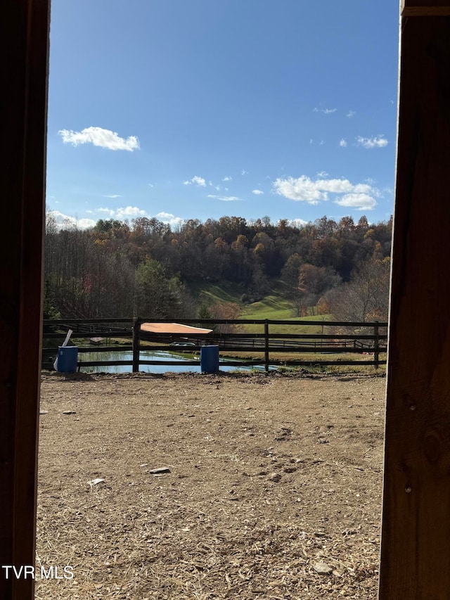 view of yard featuring a water view and a rural view