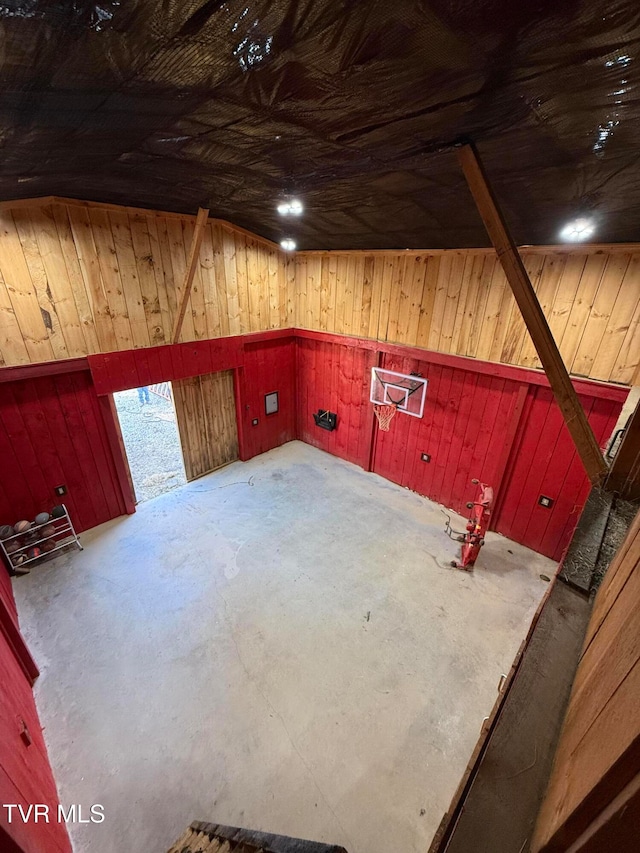 basement featuring wooden walls