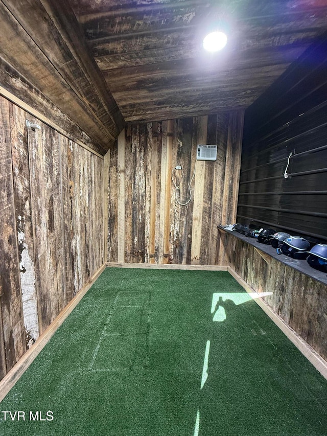 interior space with wood ceiling, wood walls, carpet, and golf simulator