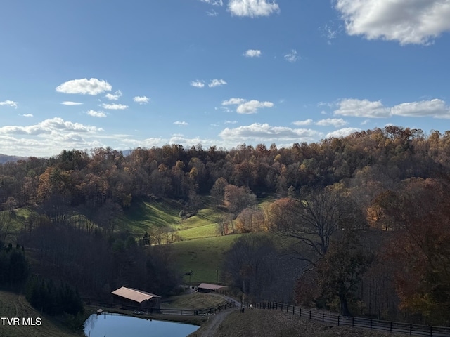 property view of mountains featuring a water view and a rural view