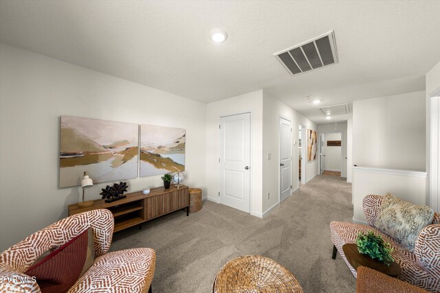 sitting room with light colored carpet