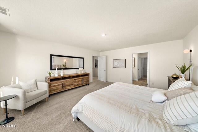 carpeted bedroom with a textured ceiling