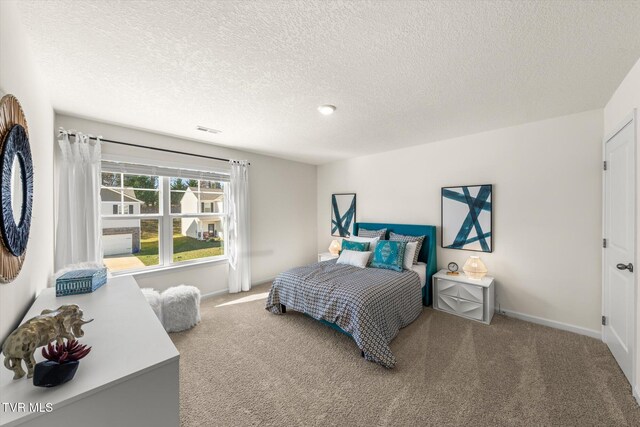 carpeted bedroom with a textured ceiling