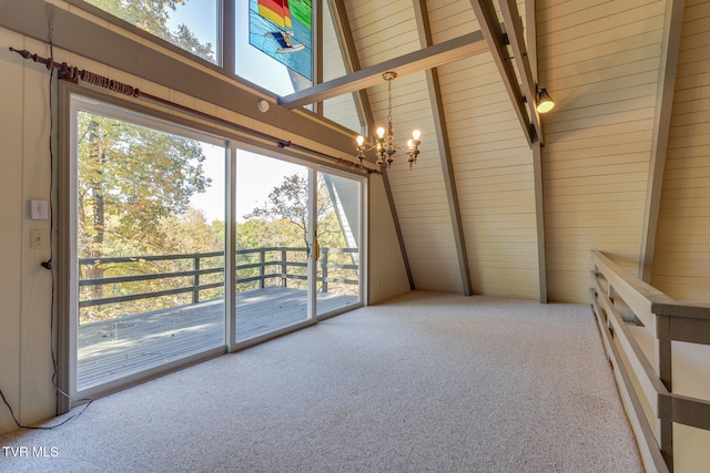 unfurnished sunroom with an inviting chandelier, lofted ceiling with skylight, and a wealth of natural light