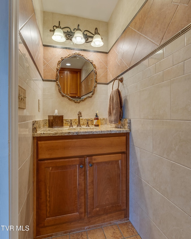 bathroom featuring tile walls and vanity