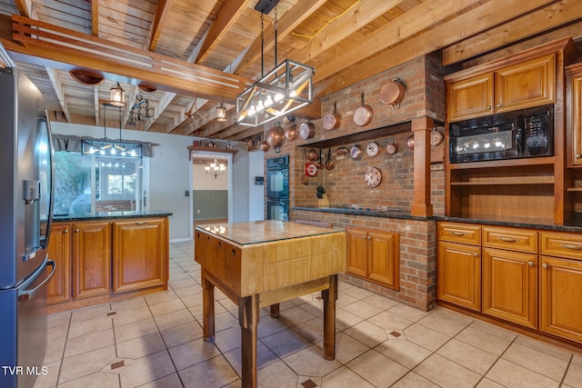 kitchen featuring light tile patterned flooring, beamed ceiling, black appliances, and pendant lighting