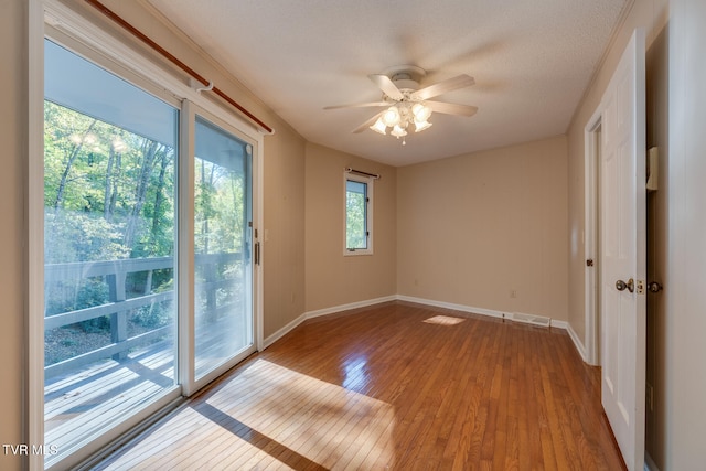 spare room with light hardwood / wood-style flooring, a textured ceiling, and ceiling fan