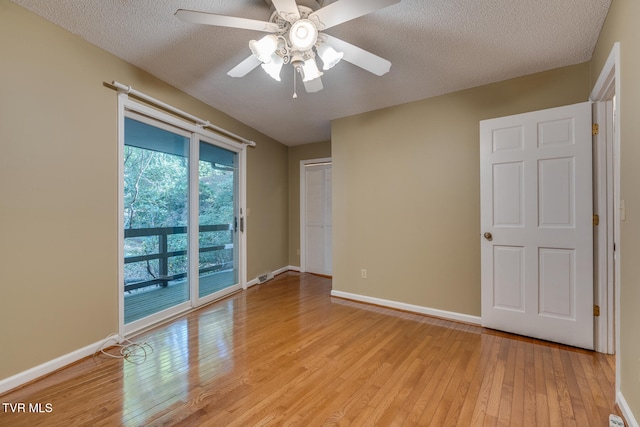 spare room with light hardwood / wood-style flooring, a textured ceiling, and ceiling fan