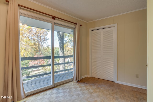 doorway to outside with light parquet flooring, a textured ceiling, and ornamental molding