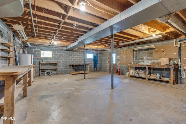 basement featuring a workshop area and water heater