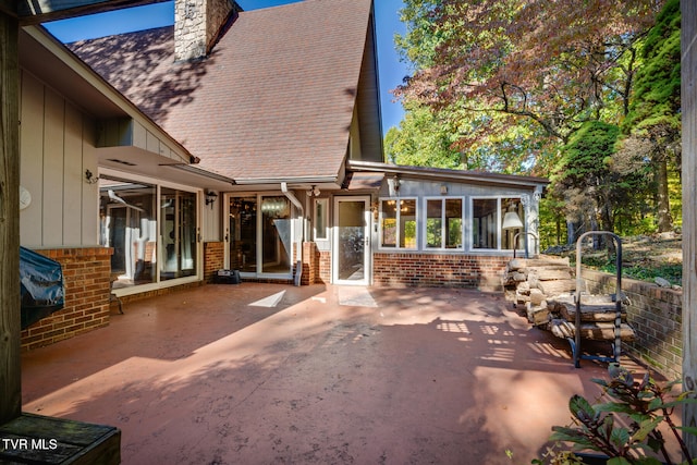 back of house with a patio area and a sunroom