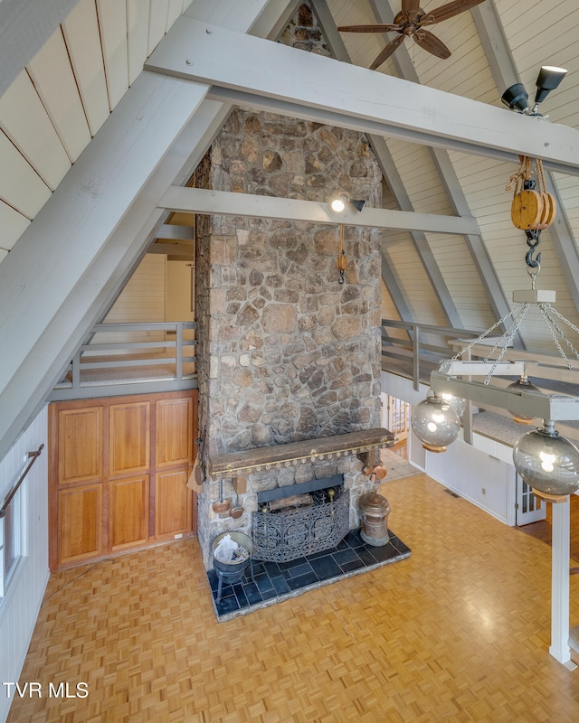 living room with beam ceiling and high vaulted ceiling