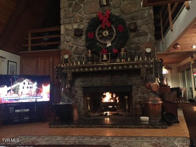 interior space featuring wood ceiling, beamed ceiling, and a fireplace