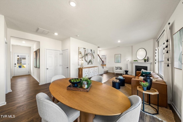 dining space with dark wood-type flooring