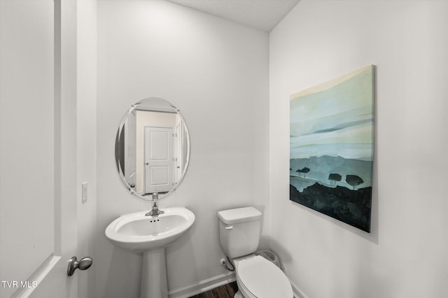 bathroom featuring a textured ceiling and toilet