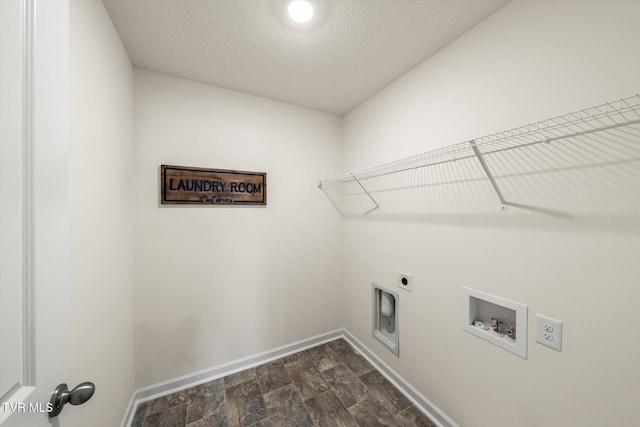 clothes washing area featuring hookup for a washing machine, hookup for an electric dryer, and a textured ceiling